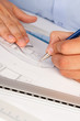 Architect working on architectural plans in the office
