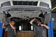 Photo: Auto mechanics working under the car - a series of MECHANIC Auto mechanics working under the car - a series of MECHANIC