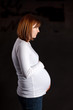 A Pregnant Mother Looking Off Camera