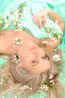 sensual woman is lying with white flowers