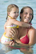 Mother and little girl in swimming pool