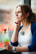 Sad woman with cocktail.