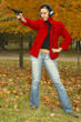 Girl  brunette in  headphones with  pistol
