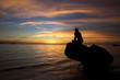 Man and beautiful sunset at tropical beach.