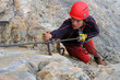 Young female climber with red helmet
