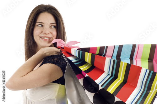 Photo: Smiling Woman with Shopping Bags Looking Back at Copyspace Smiling Woman with Shopping Bags Looking Back at Copyspace