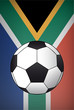soccer ball in front of the flag of south africa