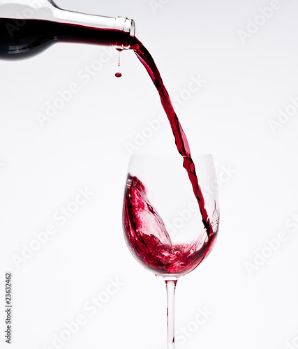 Photo: Pouring Red Wine with beautiful drops Pouring Red Wine with beautiful drops