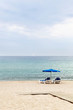 Two beach armchairs and umbrella