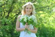 happy beautiful woman with white lilac bouquet