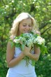 beautiful girl with white lilac bouquet