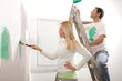 Middle aged couple painting their house
