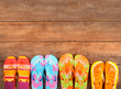 Brightly colored flip-flops on wood Brightly colored flip-flops on wood