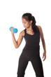 Female fitness trainer pumping dumbell , working on her arm.