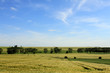 agricultural landscape and cloudy blue sky