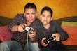 Hispanic Man and Boy Playing Video game