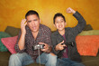 Hispanic Man and Boy Playing Video game