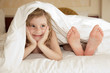 little girl and leg of mother under cover little girl and leg of mother under cover