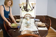 Young Woman Setting Table for a Meal