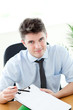Smiling businessman showing a contract to a customer