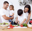 Loving young family cooking together