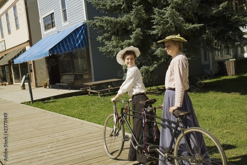 Photo: Two Women With A Vintage Bicycle Built For Two Two Women With A Vintage Bicycle Built For Two