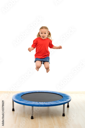 Foto: Little girl jumping on trampoline Little girl jumping on trampoline