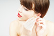 elegant woman putting on the earring