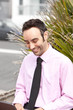 Smiling businessman lookind down at his work on a laptop