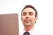Young professional with laptop looking directly at camera