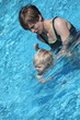 mother teaching her little daughter to swim