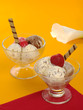 Ice-cream scoops in glass on red and orange (Selective Focus)