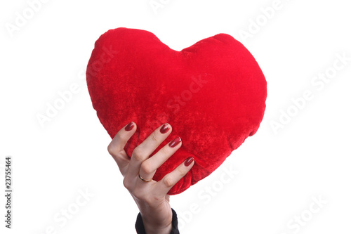 Photo: beautiful woman holding a love symbol in hands beautiful woman holding a love symbol in hands