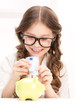 little girl with piggy bank and money little girl with piggy bank and money