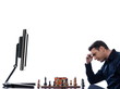 Man playing chess against computer