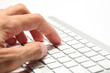 Businessman typing on a wireless computer keyboard, closeup Businessman typing on a wireless computer keyboard, closeup