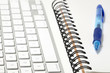 Keyboard and sketchbook concept, with a ballpoint pen Keyboard and sketchbook concept, with a ballpoint pen