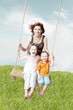 Family swing against the sky and grass