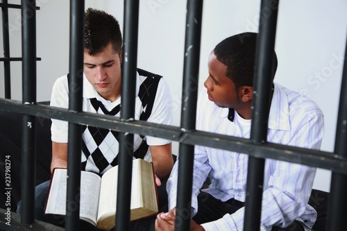 Photo: A Young Man Reads The Bible To Another Young Man In Jail A Young Man Reads The Bible To Another Young Man In Jail