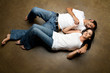 Sexy young ethnic couple relaxing on the floor