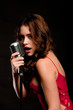 Beautiful singer singing with microphone