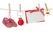 Baby goods and blank note hanging on the clothesline Baby goods and blank note hanging on the clothesline