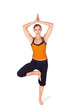 Photo: Fit Attractive Woman Practicing Yoga Tree Pose Fit Attractive Woman Practicing Yoga Tree Pose