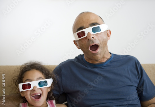 Photo: Father and daughter watching television in 3D Father and daughter watching television in 3D