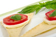 Mozzarella, tomato, basil, on crocantini (Selective Focus)