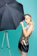 Beautiful fashion girl on the turquoise background with umbrella Beautiful fashion girl on the turquoise background with umbrella