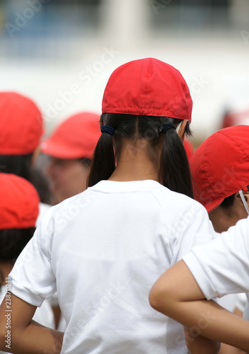 Photo: a girl wearing a red cap a girl wearing a red cap