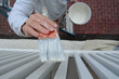 Painter Applying Paint to Exterior Balusters of Home Painter Applying Paint to Exterior Balusters of Home