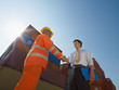 businessman and manual worker with cargo containers businessman and manual worker with cargo containers