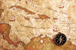 An old brass compass on a Treasure map background An old brass compass on a Treasure map background